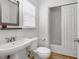 Cozy bathroom with tile flooring, a pedestal sink, and an adjacent shower and toilet room at 107 Oxford Creek Rd, Cary, NC 27519