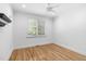 Bright bedroom with hardwood floors, a ceiling fan, and plantation shutters on the window at 107 Oxford Creek Rd, Cary, NC 27519