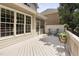View of the spacious deck with rocking chairs, a screened-in area, and ample natural light at 107 Oxford Creek Rd, Cary, NC 27519