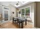 Bright dining area with hardwood floors, skylights, and a view of the outdoor deck and landscaping at 107 Oxford Creek Rd, Cary, NC 27519