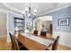 Elegant dining room with detailed crown molding, chandelier lighting, and hardwood floors, open to the living area at 107 Oxford Creek Rd, Cary, NC 27519