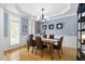 Formal dining room with wainscoting, chandelier lighting, and hardwood floors, ideal for entertaining at 107 Oxford Creek Rd, Cary, NC 27519