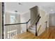 Foyer featuring hardwood floors, staircase, and decorative hanging lights at 107 Oxford Creek Rd, Cary, NC 27519