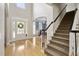 Welcoming foyer with a staircase, hardwood floors, and a view of the front door and formal dining room at 107 Oxford Creek Rd, Cary, NC 27519