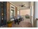 Cozy front porch with brick flooring, ceiling fan, and comfortable seating area at 107 Oxford Creek Rd, Cary, NC 27519