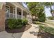 Charming home featuring a covered front porch with white columns and landscaped garden at 107 Oxford Creek Rd, Cary, NC 27519