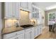 Well-equipped kitchen featuring granite countertops, tiled backsplash, white cabinetry and modern appliances at 107 Oxford Creek Rd, Cary, NC 27519