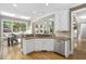 Open kitchen featuring granite counters, white cabinets, stainless steel appliances, and a view into the dining area at 107 Oxford Creek Rd, Cary, NC 27519