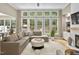 Bright living room with large windows, plush sectional sofa, and stylish decor at 107 Oxford Creek Rd, Cary, NC 27519