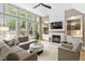 Inviting living room featuring a fireplace, built-in shelves, and large windows offering backyard views at 107 Oxford Creek Rd, Cary, NC 27519