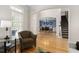 Open-concept living room with large windows, hardwood floors, and an archway leading to the dining room at 107 Oxford Creek Rd, Cary, NC 27519