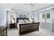 Comfortable main bedroom featuring tray ceiling, soft carpet, and bright, light-filled windows at 107 Oxford Creek Rd, Cary, NC 27519
