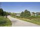 Scenic walking path next to the pond, featuring a bin, bench and community sign at 107 Oxford Creek Rd, Cary, NC 27519