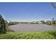 Image of a calm community pond surrounded by lush greenery and trees at 107 Oxford Creek Rd, Cary, NC 27519
