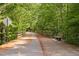 View of the shaded community walking trail with benches and a wooden fence at 107 Oxford Creek Rd, Cary, NC 27519