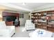 Finished basement featuring built-in bookshelves, comfortable seating, and a TV area at 11 Whitburn Pl, Durham, NC 27705