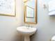 Charming bathroom features a pedestal sink, mirror, and neutral wall color at 11 Whitburn Pl, Durham, NC 27705