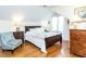 This bedroom features hardwood floors, a bed with white bedding, and two dressers at 11 Whitburn Pl, Durham, NC 27705