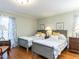 Shared bedroom with hardwood flooring, two twin beds, and neutral wall color at 11 Whitburn Pl, Durham, NC 27705