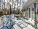 Sun-drenched deck with glass topped table and access to the house, great for enjoying the wooded view at 11 Whitburn Pl, Durham, NC 27705