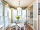 Breakfast nook featuring hardwood floors, a glass top table, views of the sink, and lots of natural light at 11 Whitburn Pl, Durham, NC 27705