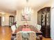 Elegant dining room features a chandelier, hardwood flooring, and decorative china cabinet at 11 Whitburn Pl, Durham, NC 27705