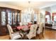 Elegant dining room features a chandelier, decorative china cabinet, and seating for six at 11 Whitburn Pl, Durham, NC 27705