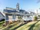Charming home exterior with well-maintained lawn, deck, and a classic architectural design at 11 Whitburn Pl, Durham, NC 27705