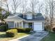 Charming one-story home features a manicured lawn, gray siding, and an attached one car garage at 11 Whitburn Pl, Durham, NC 27705