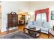 Comfortable living room with hardwood flooring, sofa, chair and access to the dining room at 11 Whitburn Pl, Durham, NC 27705