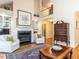 Bright living room with fireplace, hardwood floors, and open floor plan to the second story at 11 Whitburn Pl, Durham, NC 27705