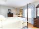 This is a main bedroom with hardwood floors, a four-poster bed, and colorful window treatments at 11 Whitburn Pl, Durham, NC 27705