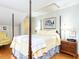 This bedroom features a four-poster bed, hardwood floors, and light green colored walls at 11 Whitburn Pl, Durham, NC 27705