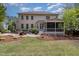 Backyard view featuring a patio, screened-in porch, well-maintained lawn, and mature landscaping at 112 Aspenridge Dr, Holly Springs, NC 27540