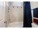 Well-lit bathroom featuring a shower-tub combo with blue accents, offering a functional and inviting space at 112 Aspenridge Dr, Holly Springs, NC 27540