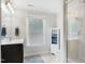 Bright bathroom with vanity, shower, and toilet, complemented by a large window at 112 Aspenridge Dr, Holly Springs, NC 27540