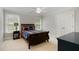 This bedroom is a serene retreat featuring a wooden sleigh bed, natural light, and neutral walls at 112 Aspenridge Dr, Holly Springs, NC 27540