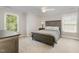 Cozy bedroom featuring neutral walls, two windows and a wooden headboard for a relaxed atmosphere at 112 Aspenridge Dr, Holly Springs, NC 27540