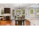 Bright dining area with hardwood floors, large windows, and a chandelier at 112 Aspenridge Dr, Holly Springs, NC 27540