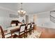 Spacious dining area with hardwood floors, wainscoting, and a chandelier at 112 Aspenridge Dr, Holly Springs, NC 27540