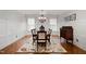 Formal dining room with wainscoting, a decorative chandelier, and a hardwood floor at 112 Aspenridge Dr, Holly Springs, NC 27540