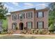 Charming two-story brick home with a landscaped front yard and classic architectural details at 112 Aspenridge Dr, Holly Springs, NC 27540