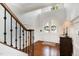 Grand foyer featuring a staircase with dark wood railings and a bright, airy feel at 112 Aspenridge Dr, Holly Springs, NC 27540
