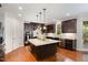 Spacious kitchen features dark cabinets, stainless steel appliances, granite counters and large center island at 112 Aspenridge Dr, Holly Springs, NC 27540