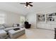 Comfortable living room with neutral colors, plush seating, and built-in bookshelves at 112 Aspenridge Dr, Holly Springs, NC 27540