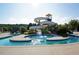 Community pool featuring a water slide and surrounding seating areas at 112 Aspenridge Dr, Holly Springs, NC 27540