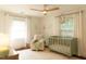 Bright Bedroom featuring a crib, comfortable chair and natural light at 112 E Edgewood Dr, Durham, NC 27704