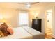 Comfortable bedroom with hardwood floors, a cozy bed, natural light, and a bathroom view at 112 E Edgewood Dr, Durham, NC 27704