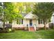 Charming bungalow with mature trees, walkway, and covered front porch at 112 E Edgewood Dr, Durham, NC 27704