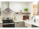 Well-equipped kitchen with stainless steel appliances, white subway tile backsplash, and open shelving at 112 E Edgewood Dr, Durham, NC 27704